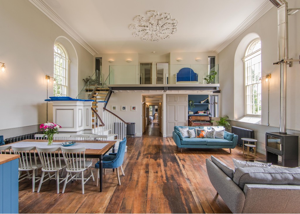 Bright open-plan living space in a converted church with mezzanine bedroom in County Down.
