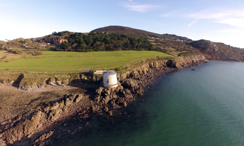 Historic Martello tower on a rocky headland near Sutton, County Dublin.