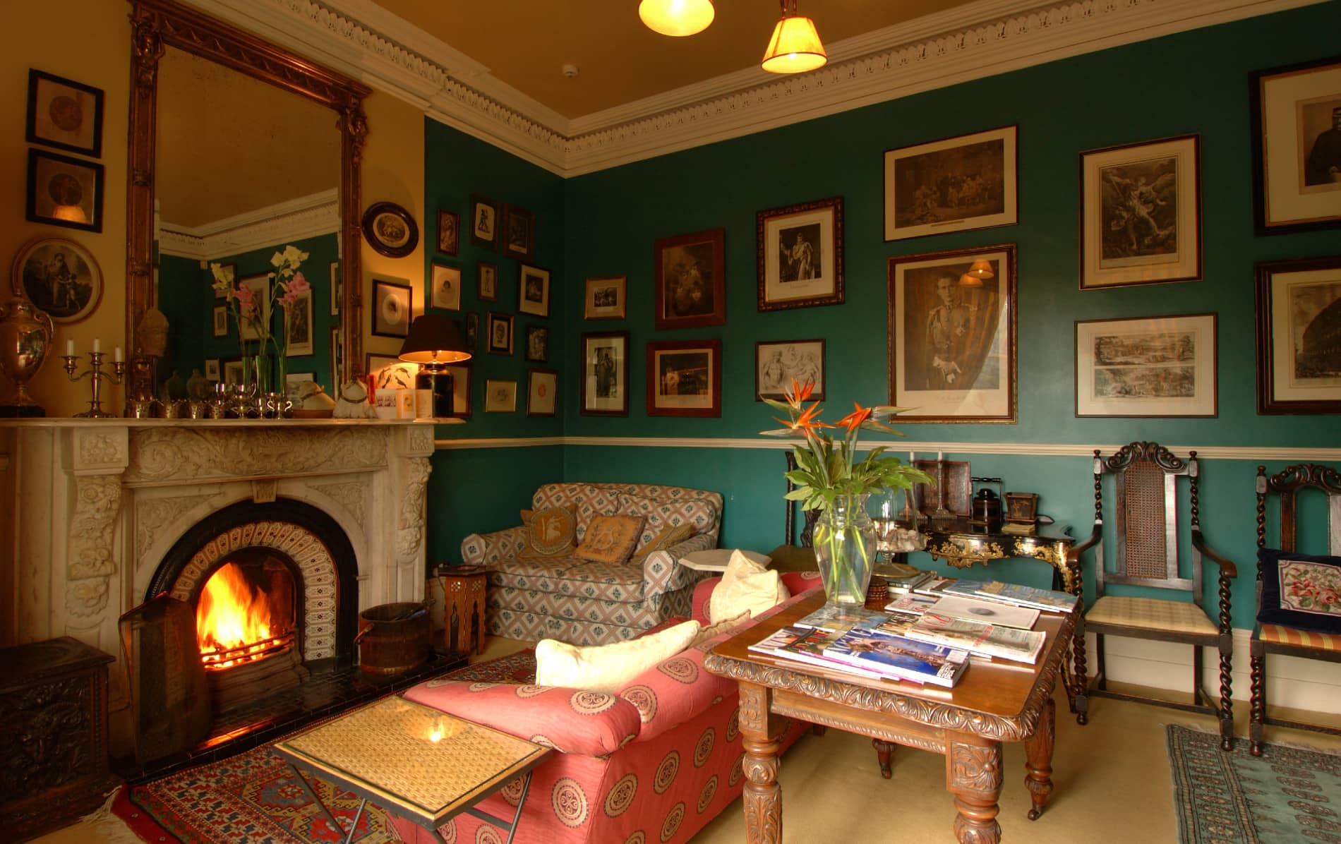 Traditional parlour with roaring fireplace and vintage decor at The Mustard Seed at Echo Lodge, County Limerick.