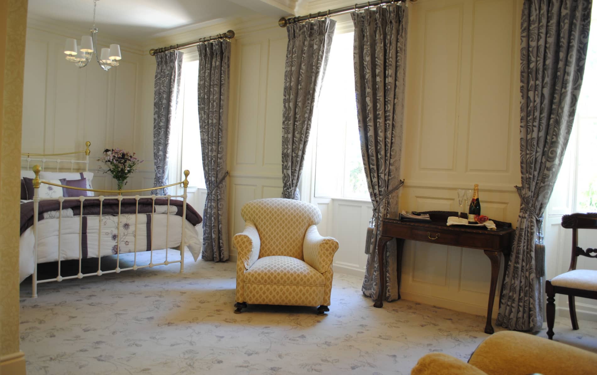 Bright period-style bedroom at cosy Killiane Castle in County Wexford, with champagne and floral décor.