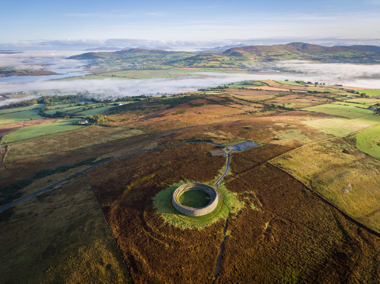 Grianán of Aileach stone ringfort on a hilltop with sweeping views of valleys in County Donegal.