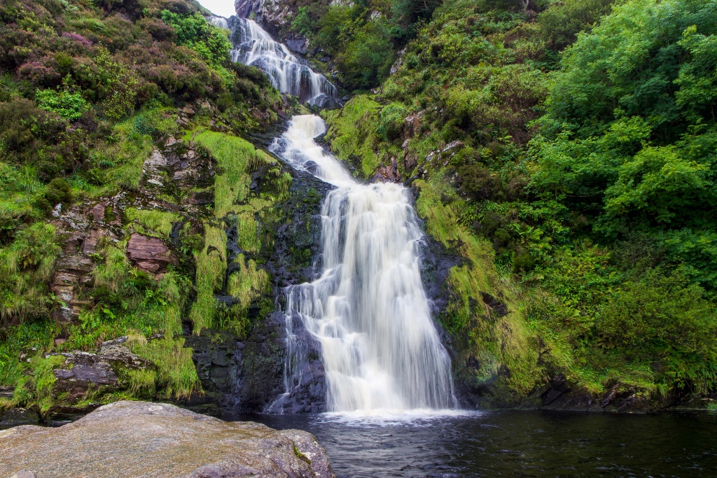 Water cascading over mossy rocks at Assaranca Waterfall near Ardara. 