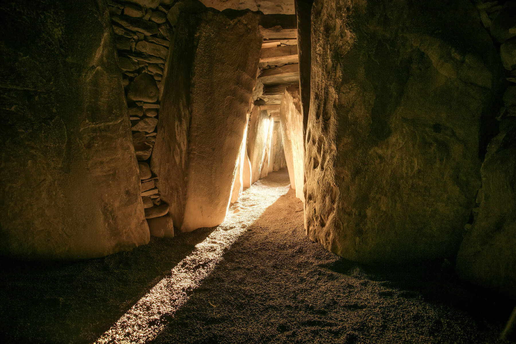 Sunlight streaming along the stone passageway inside Newgrange’s ancient burial mound.