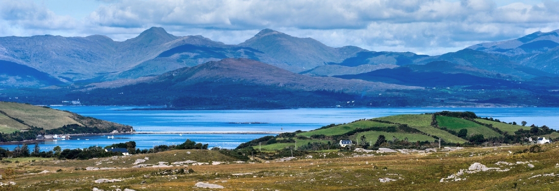 View across Kenmare Bay from the Cronin’s Yard Loop walk in County Kerry showing blue water and rugged mountains.