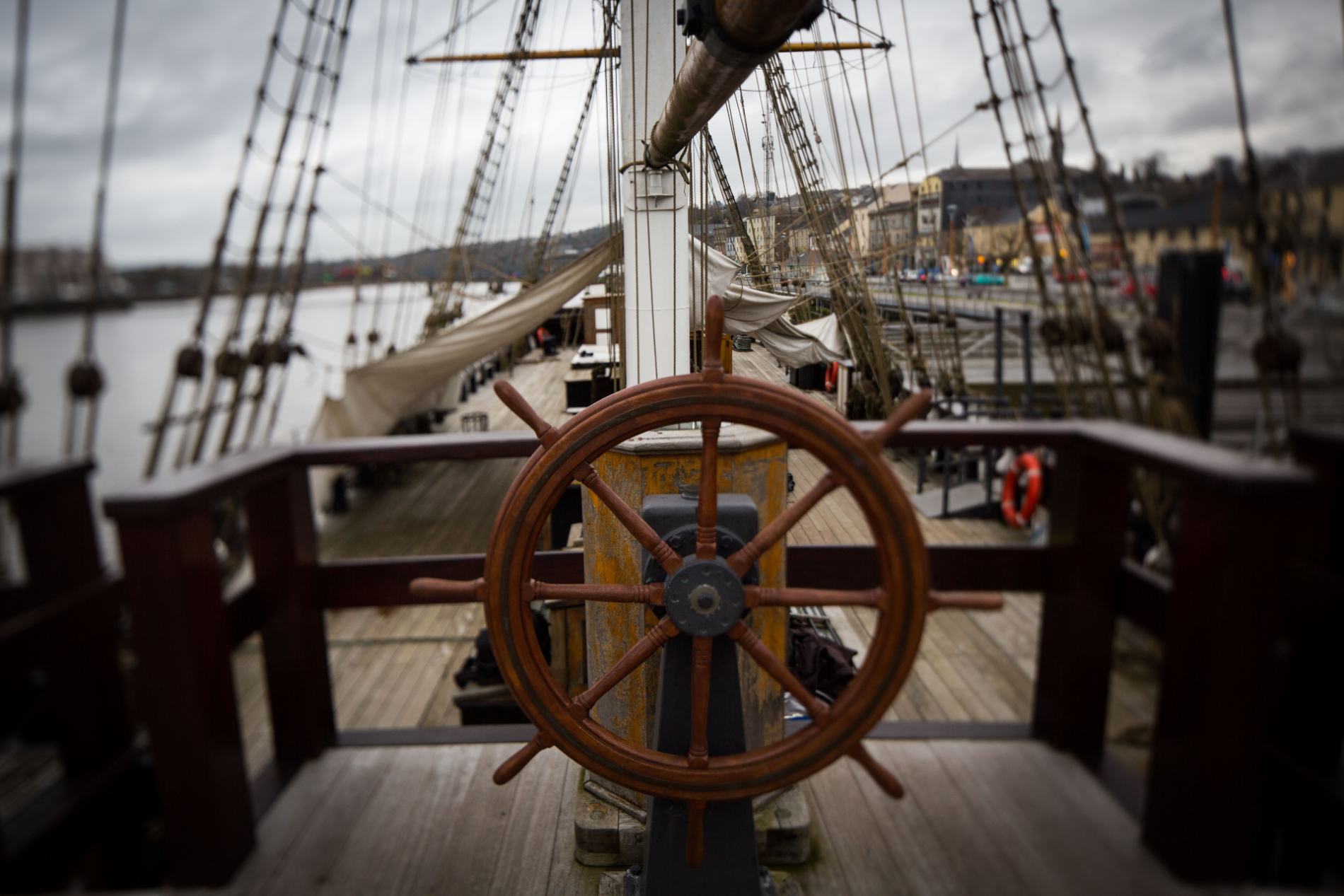 Wooden ship’s wheel and rigging overlooking New Ross Quay in County Wexford, evoking Ireland’s maritime heritage.