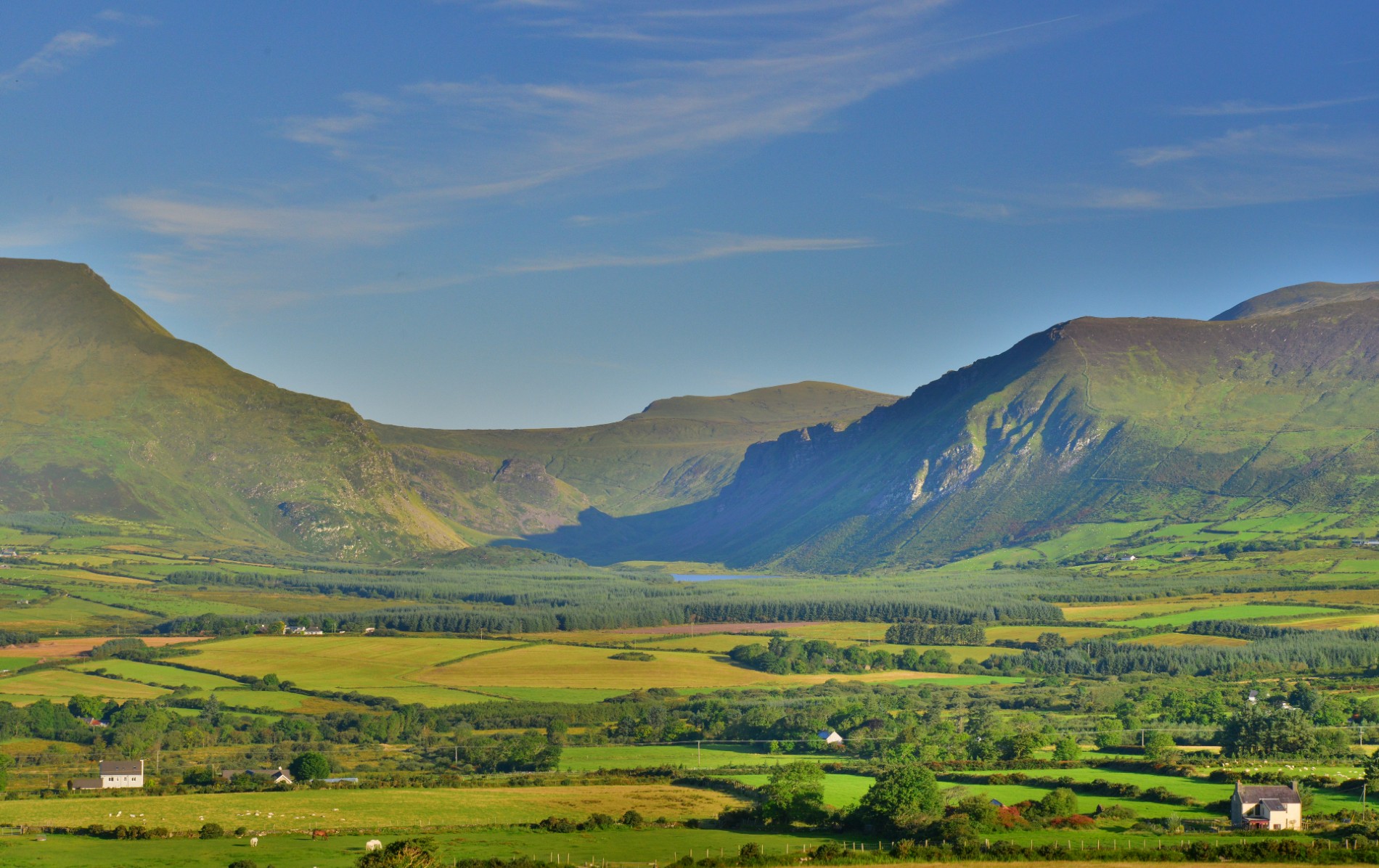 Green valley and mountain views at Annascaul Lake in County Kerry.