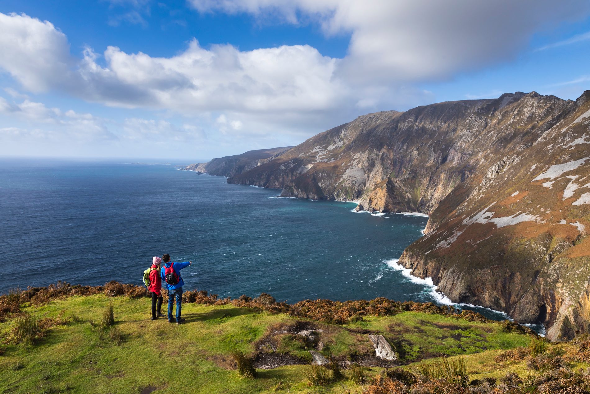Steep sea cliffs at Slieve League, County Donegal, meeting the Atlantic Ocean under a cloudy sky.