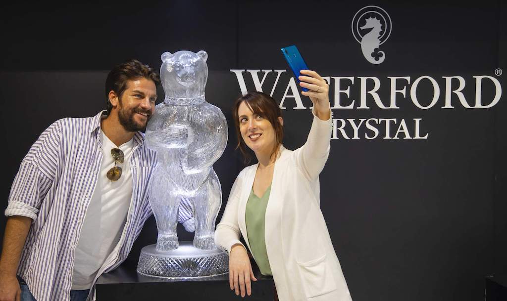 A couple takes a selfie beside a crystal bear sculpture at the House of Waterford Crystal in Waterford.