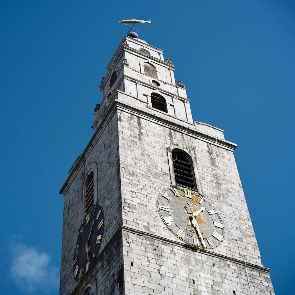 Shandon Bells clock tower in Cork City, historic landmark with fish weathervane against clear blue sky.