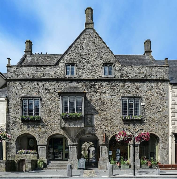 Rothe House in Kilkenny, a restored medieval merchant townhouse with stone arches and flower boxes.