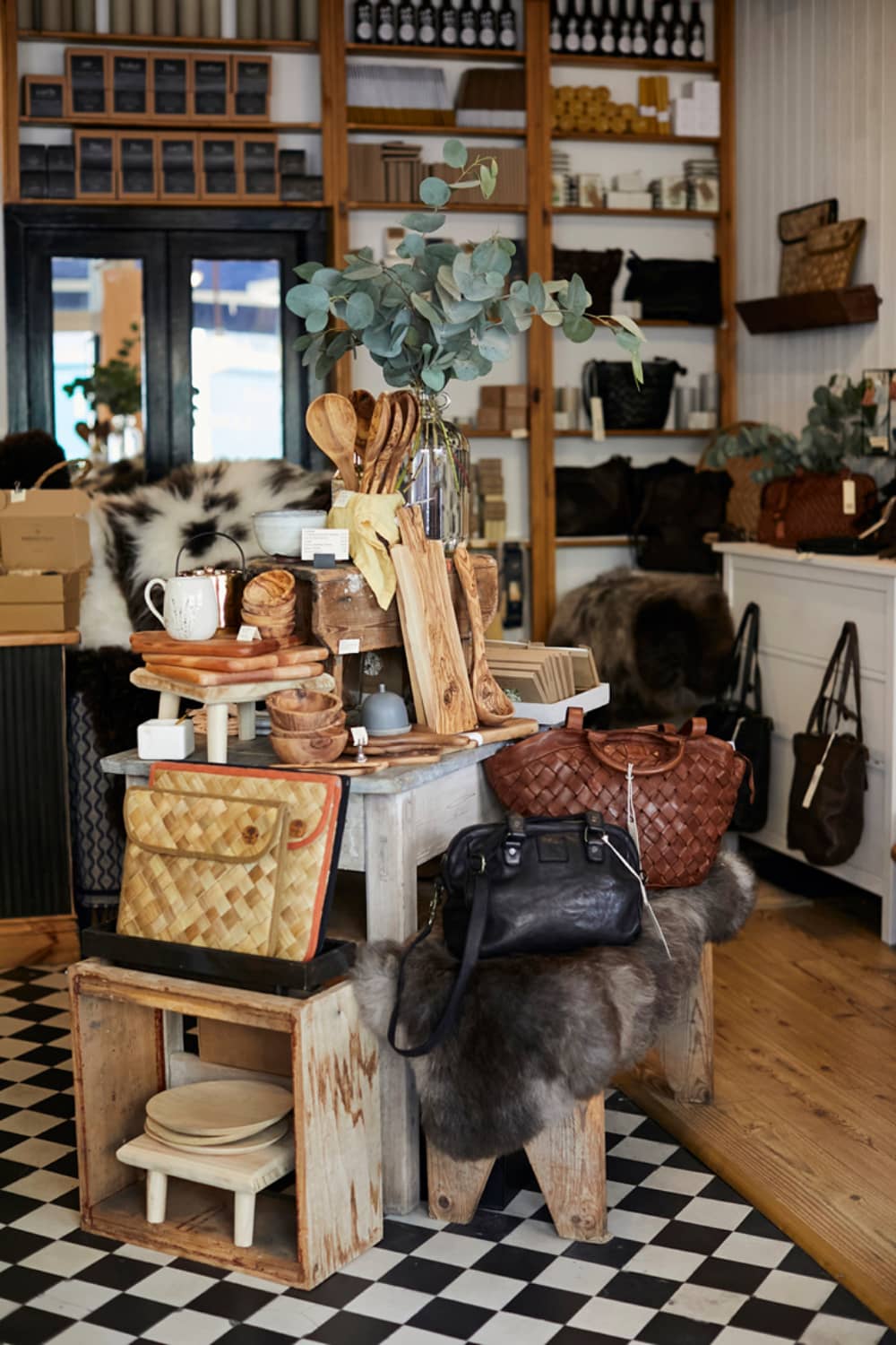 Interior of Crinkle Stores, Dingle, with handcrafted goods, leather bags, and artisan wooden kitchenware.