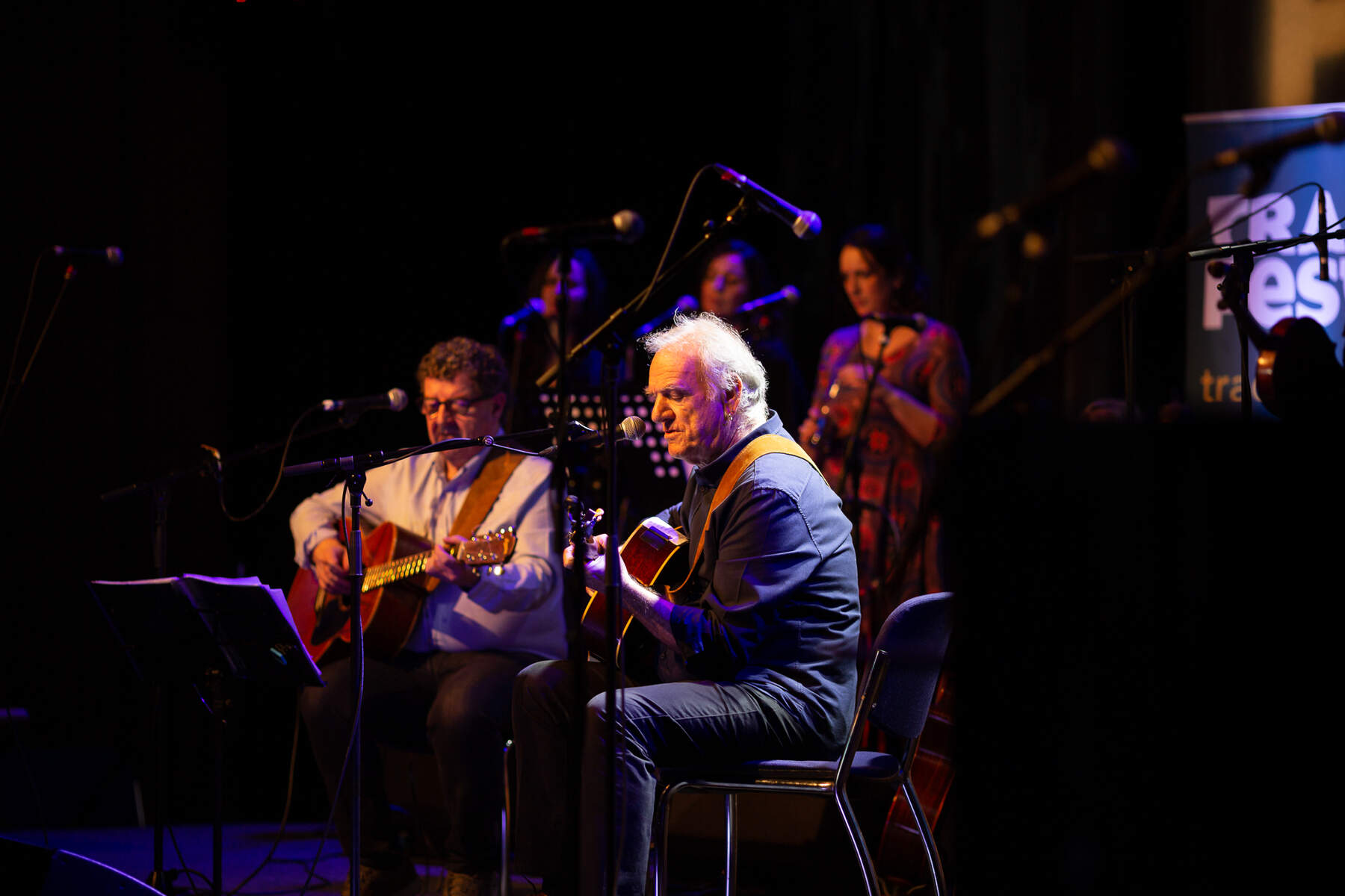 Musicians playing guitars on stage at Dublin’s TradFest music festival.