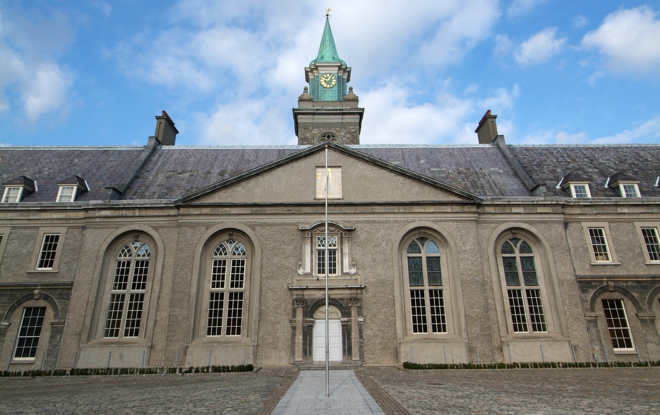 Façade of the Royal Hospital Kilmainham in Dublin with clock tower against a blue sky.