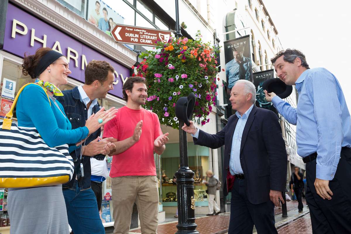 Street performers entertaining a group during the Dublin Literary Pub Crawl.