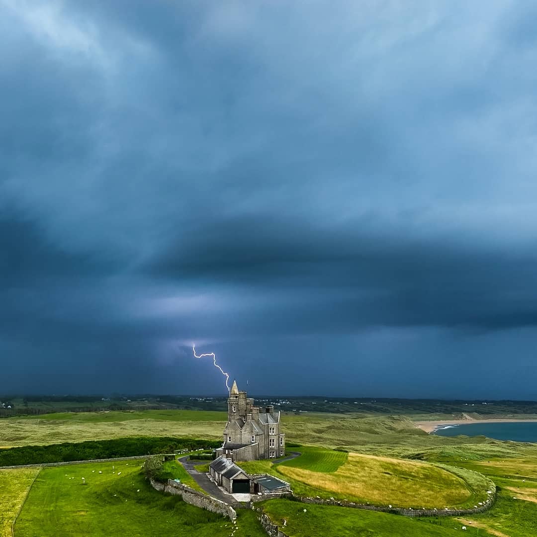 Lightning bolt striking near Classiebawn Castle under stormy skies on the Atlantic coast in County Sligo.
