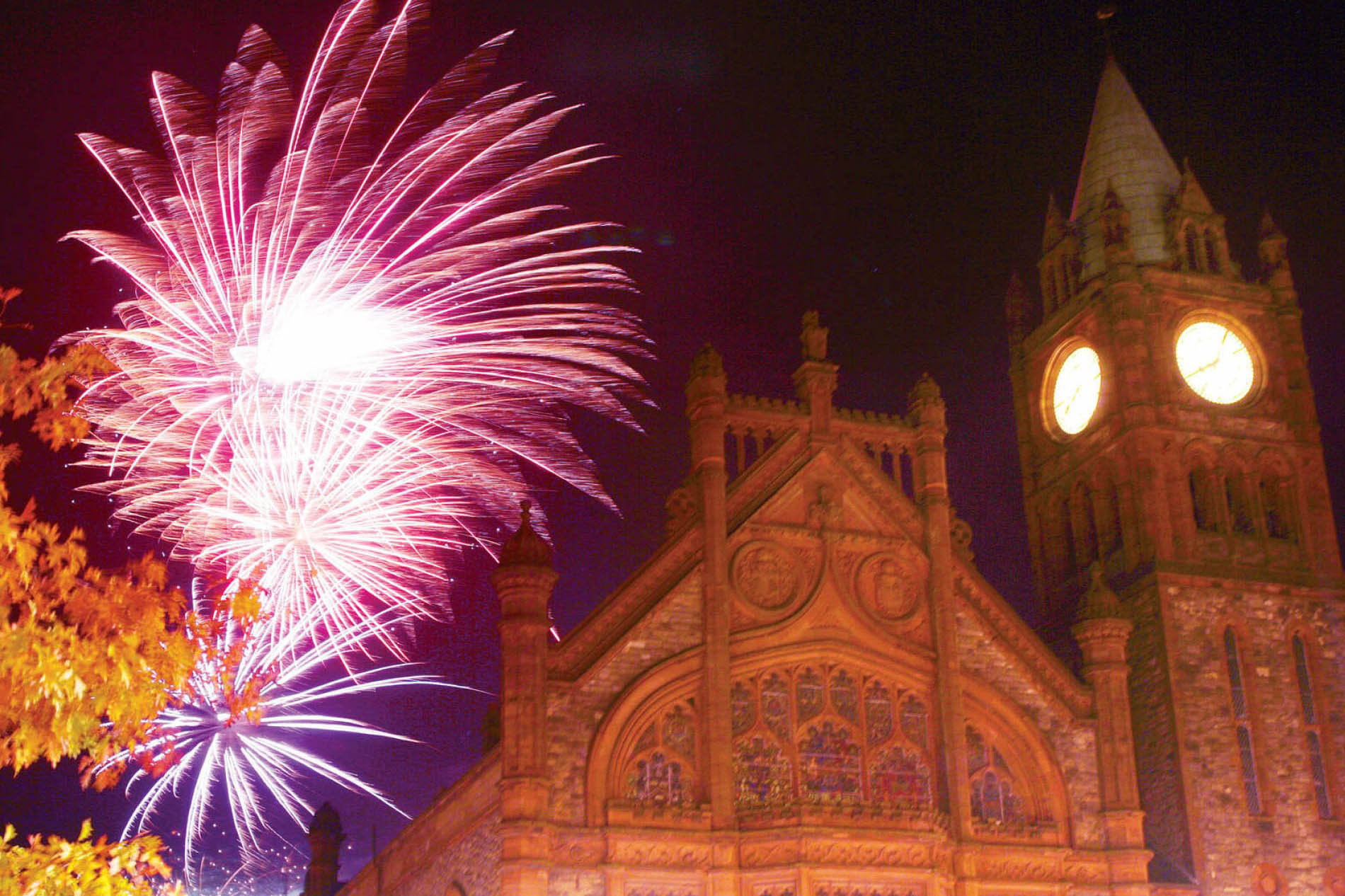 Fireworks lighting up the night sky above the Guildhall in Derry~Londonderry, Northern Ireland, for Derry Halloween.