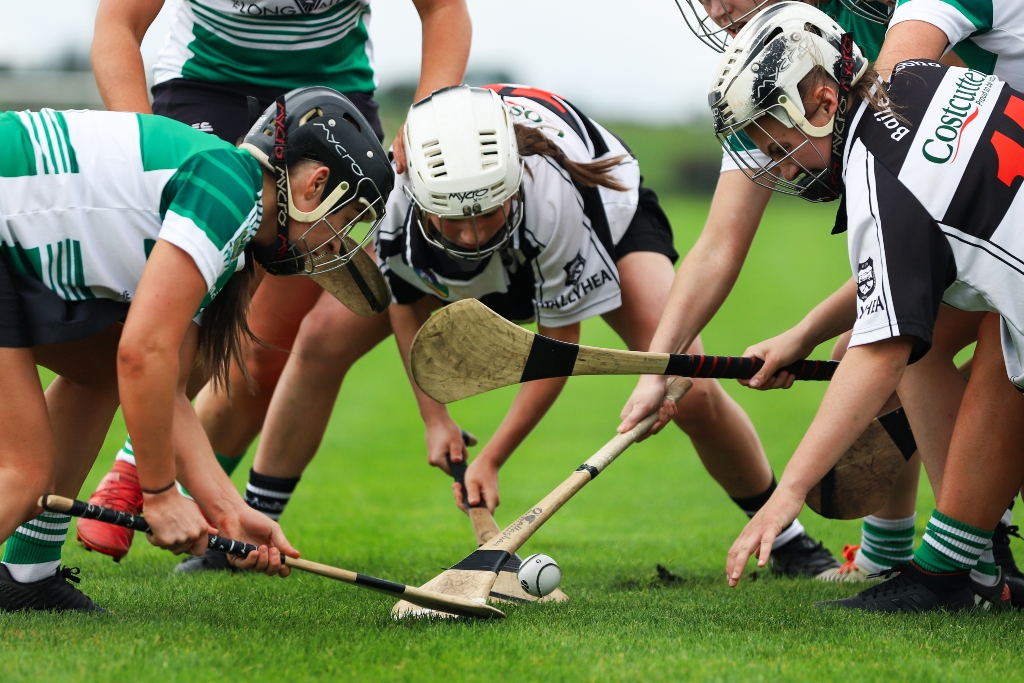Group of camogie players from opposing teams battle for possession of the sliotar during a junior championship in Cork.