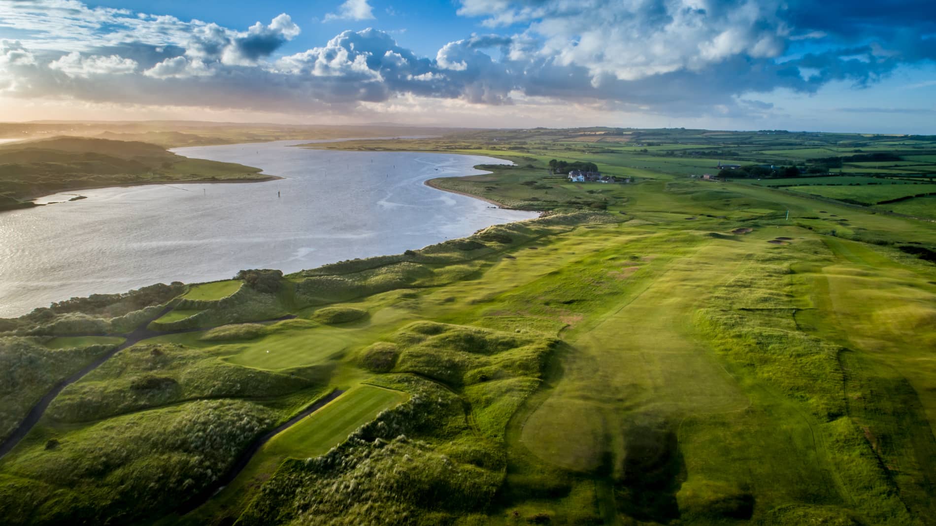 Aerial view of Castlerock Golf Course, County Londonderry, overlooking lush fairways and a winding river.