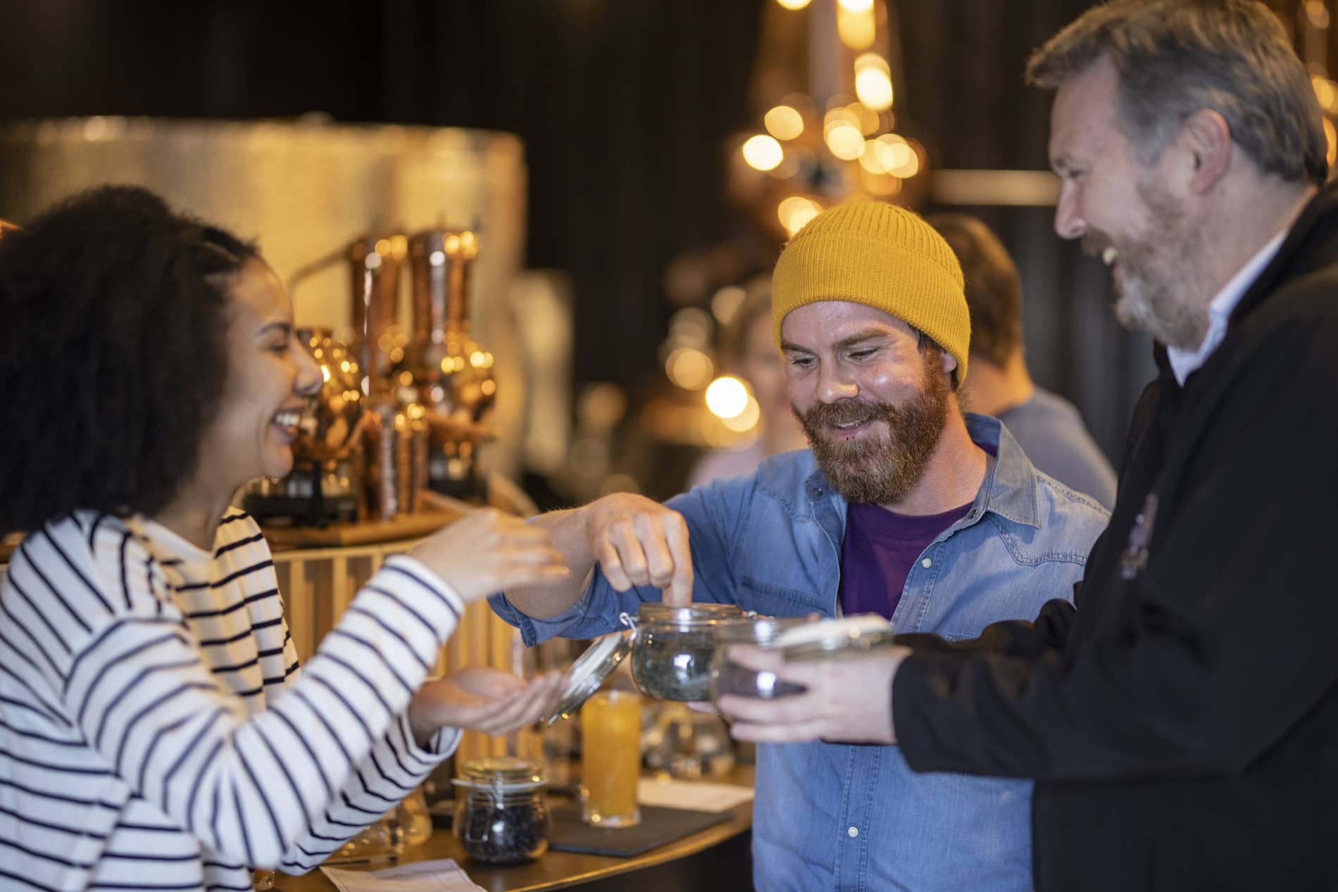 Visitors laughing and sampling botanicals at the Wild Atlantic Distillery in County Tyrone.