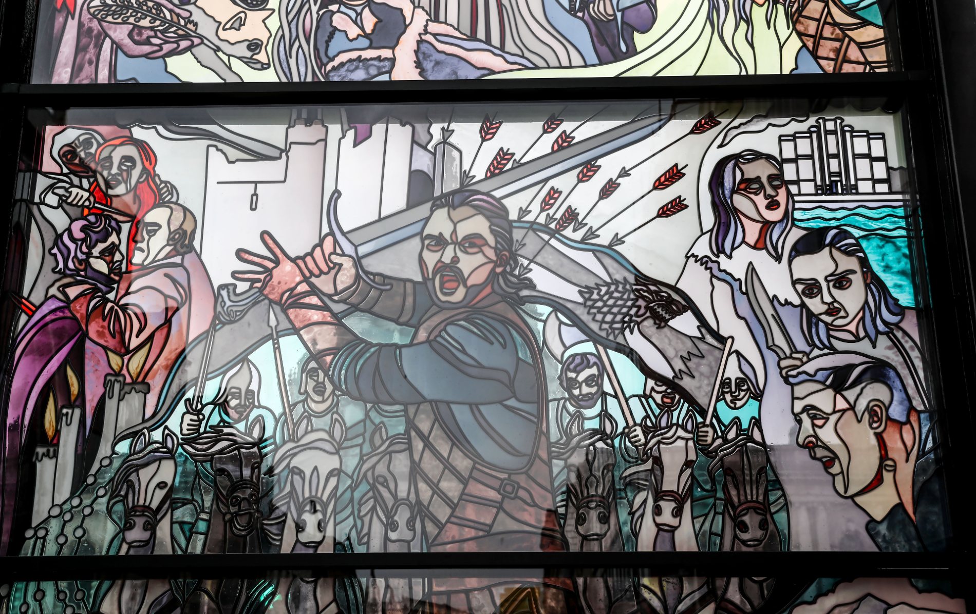 Stained glass at City Quays with Jon Snow, Stark sigil, Arya, Sansa, and vivid battle imagery from the series.