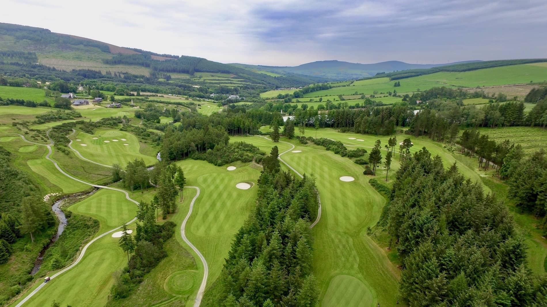 Macreddin Golf Course, County Wicklow, with fairways winding through valleys and forest.