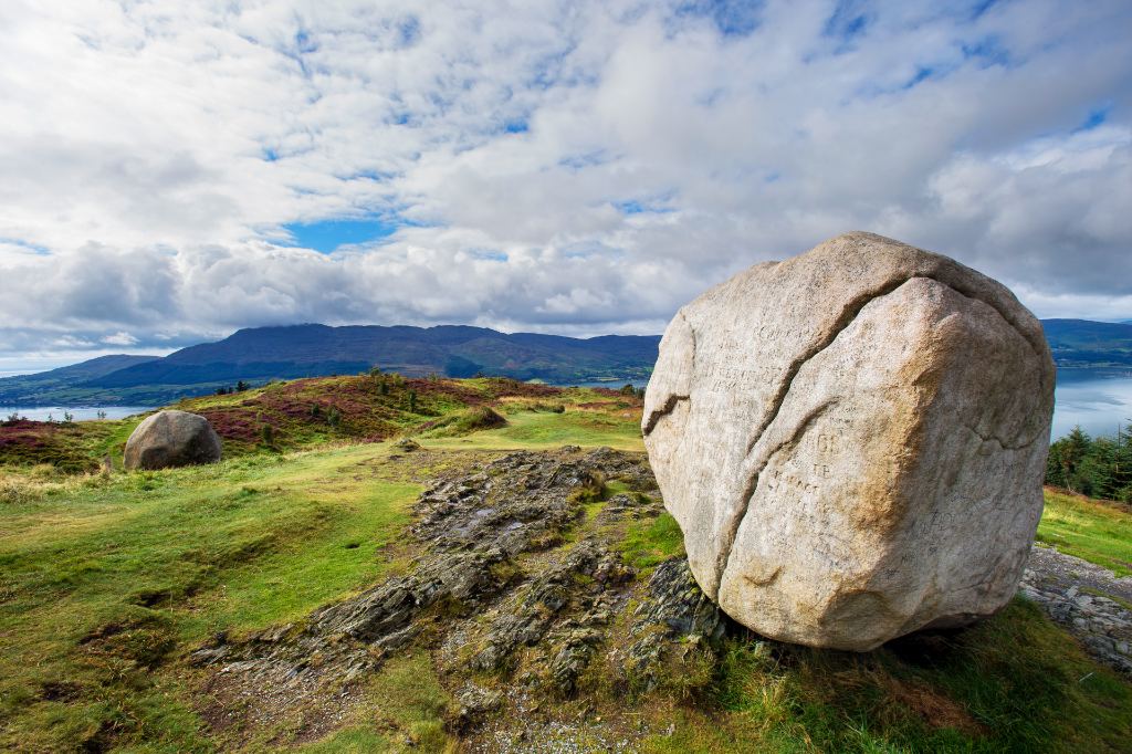 The Cloughmore Stone in County Down with carved script overlooking Carlingford Lough and Cooley Mountains.