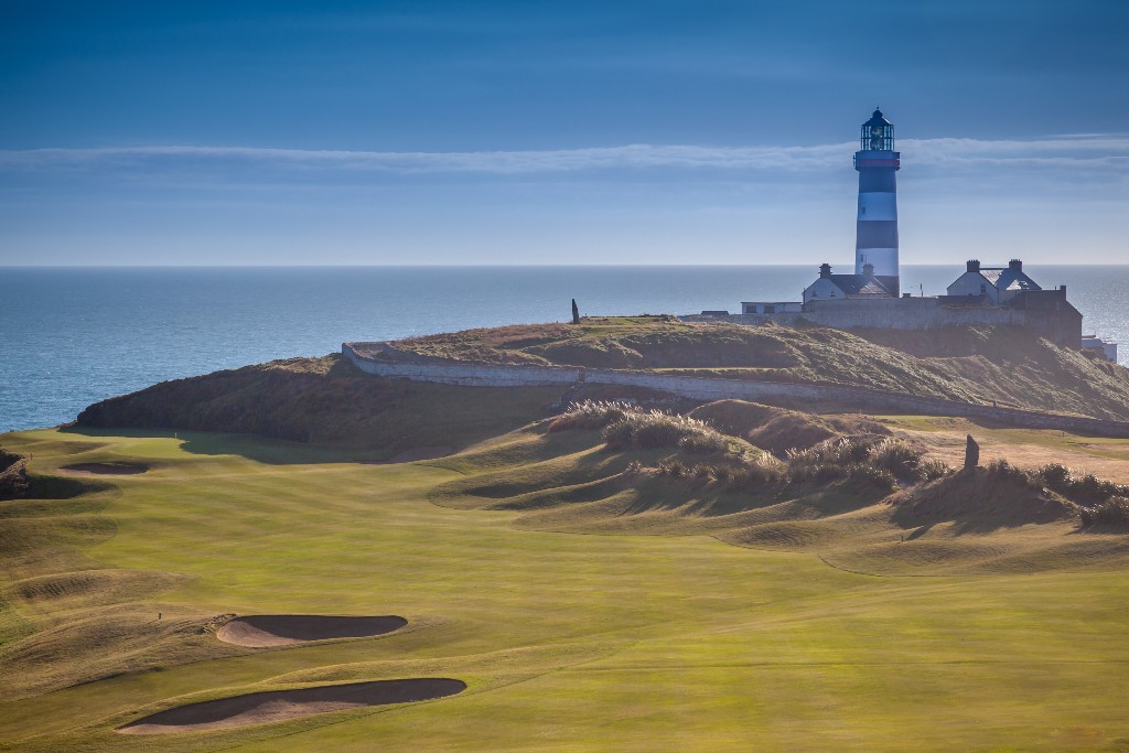 Golf course with a lighthouse overlooking the sea, representing twin golfers Lisa and Leona Maguire.