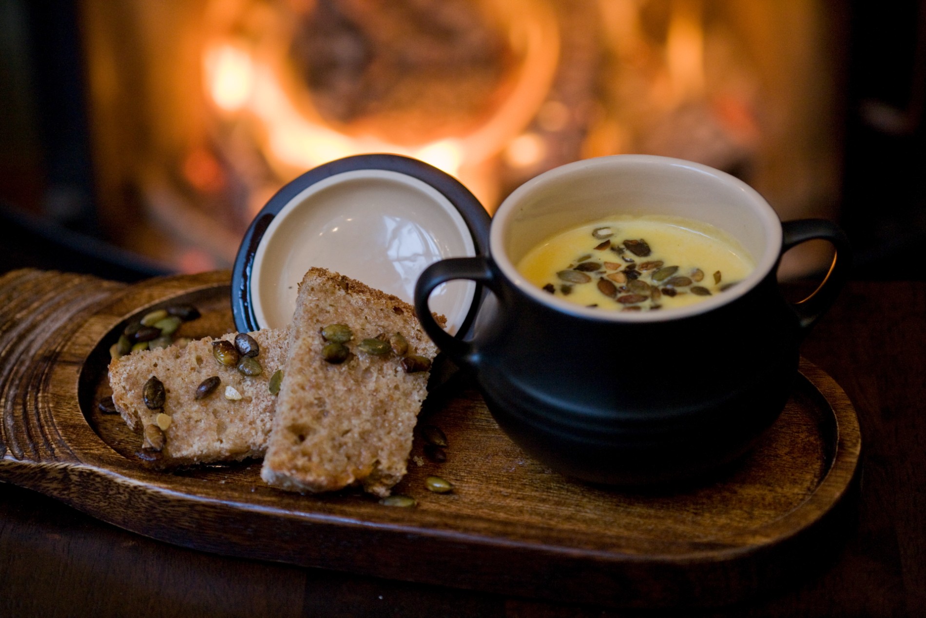 Bowl of soup with soda bread topped with seeds served by the fire at Grace Neill’s pub in Donaghadee, County Down.
