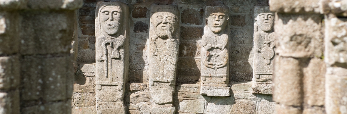 Close-up of carved stone figures on White Island, County Fermanagh, depicting early medieval religious imagery.