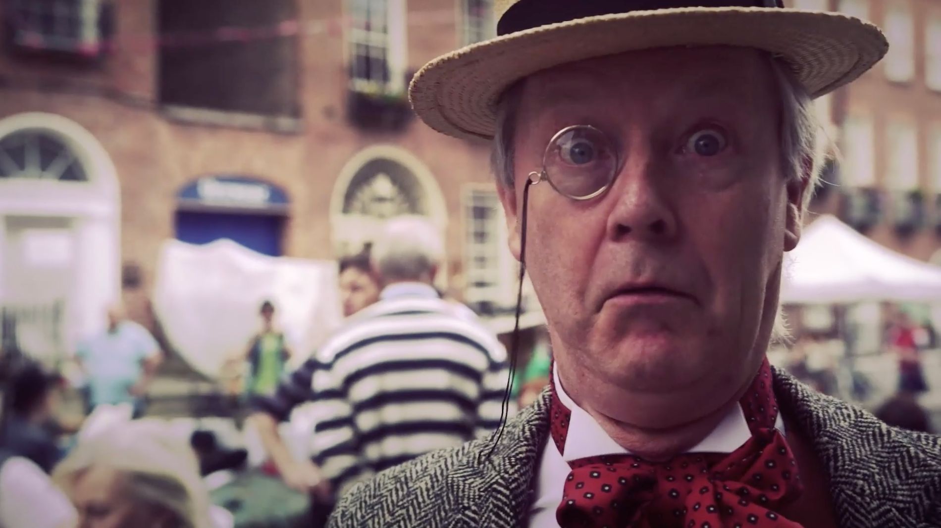 Performer in Edwardian costume with monocle at Bloomsday Festival in Dublin, referencing James Joyce’s Ulysses.