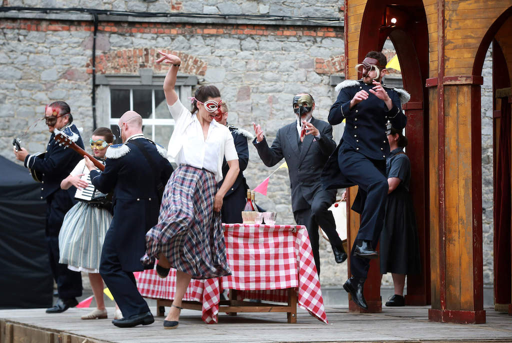 Actors in masks performing an outdoor play during Kilkenny Arts Festival.