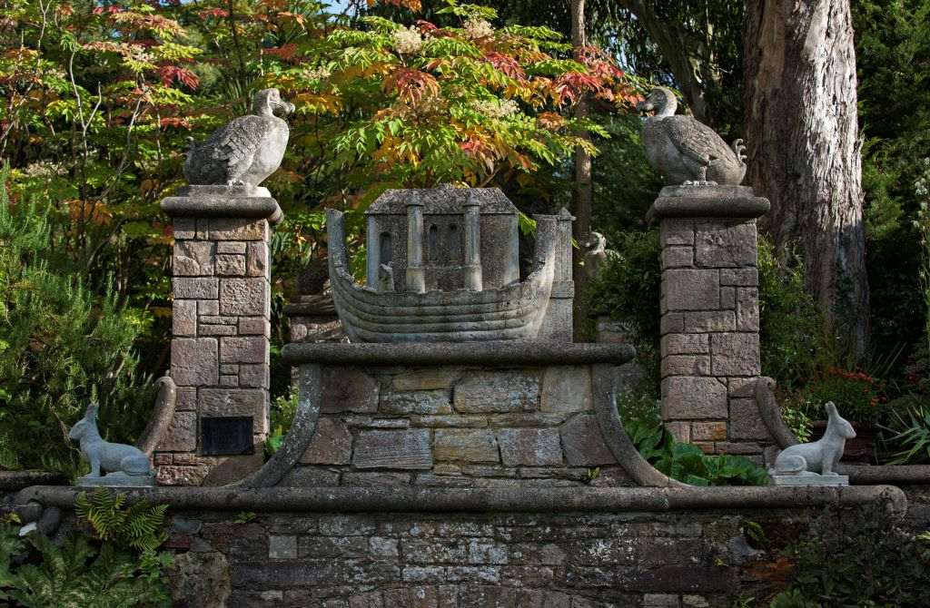 Ornate stone sculpture of Noah’s Ark with animal carvings in the lush gardens of Mount Stewart.