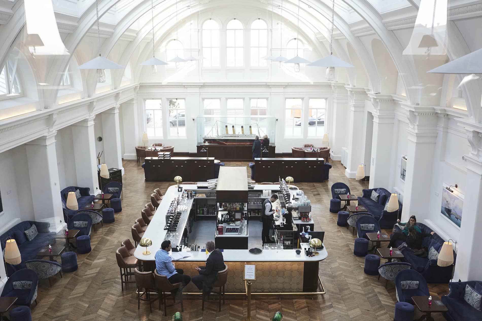 Bar at Titanic Hotel in Belfast’s former Harland and Wolff Drawing Offices with vaulted white ceilings.