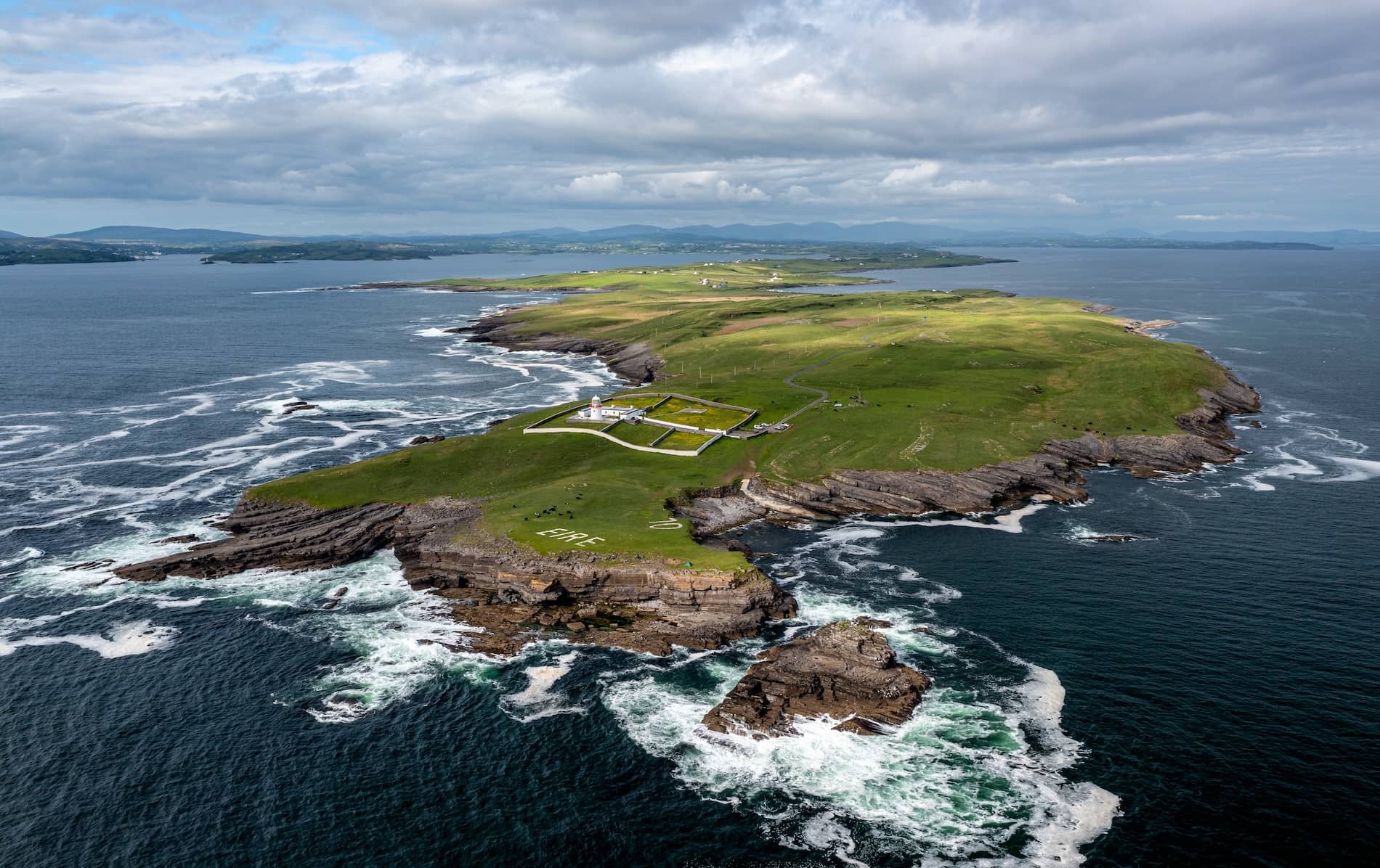 Aerial view of St John’s Point peninsula with dramatic Atlantic cliffs and rolling pastures in Donegal.