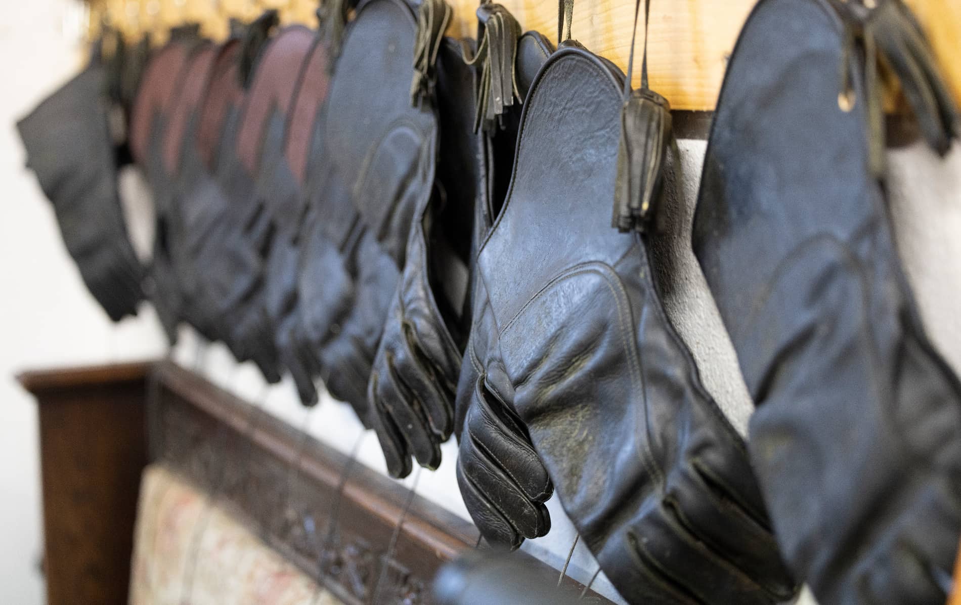 A row of black leather falconry gloves hanging in a training room at Ashford Castle, County Mayo.