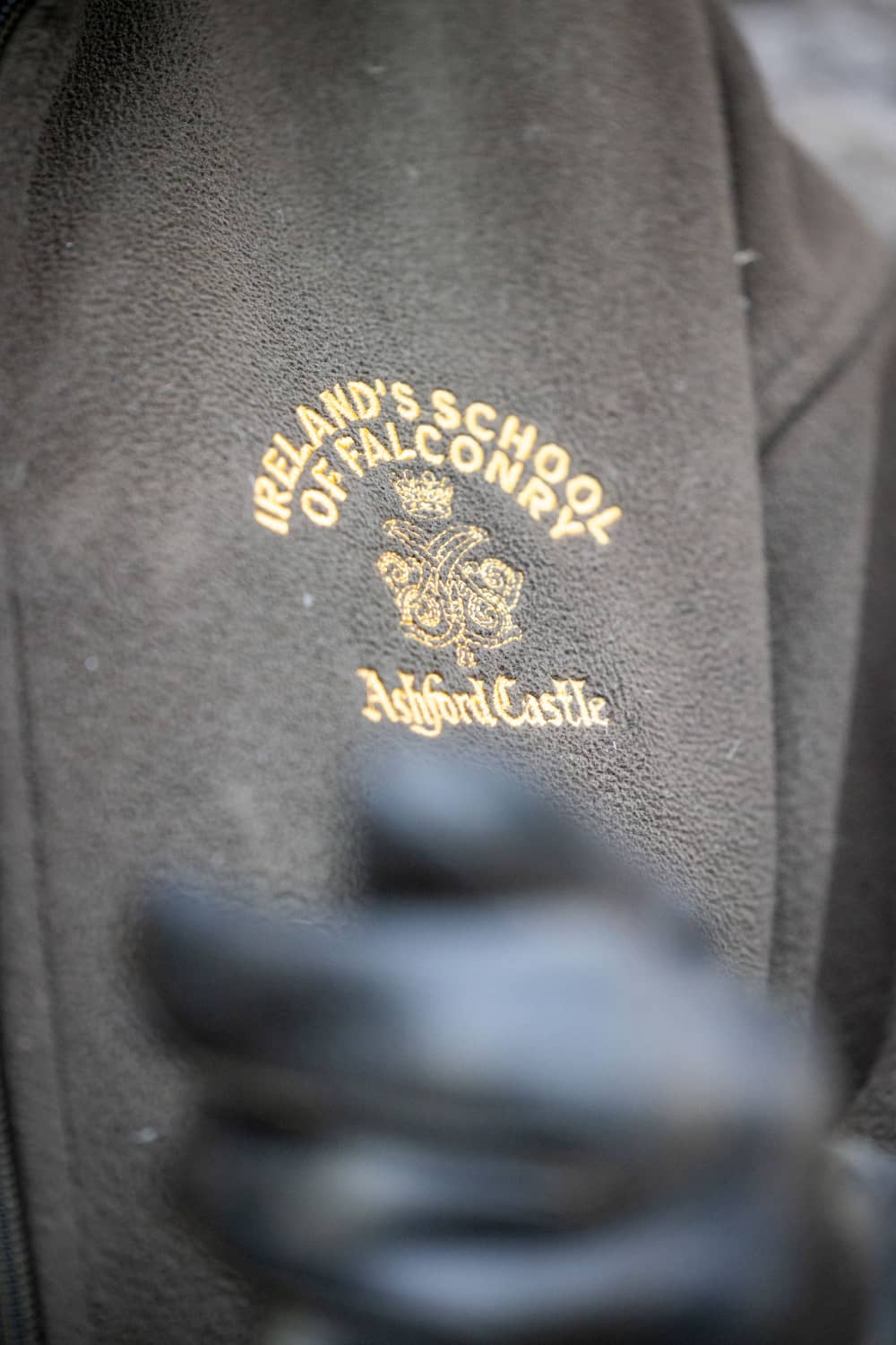 Close-up of a brown fleece embroidered with the Ireland’s School of Falconry logo at Ashford Castle.