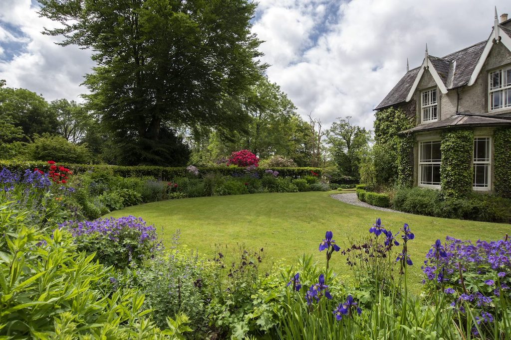 Colourful flowers and trimmed lawns surround The Old Rectory at Blackstairs Eco Trails, County Carlow.