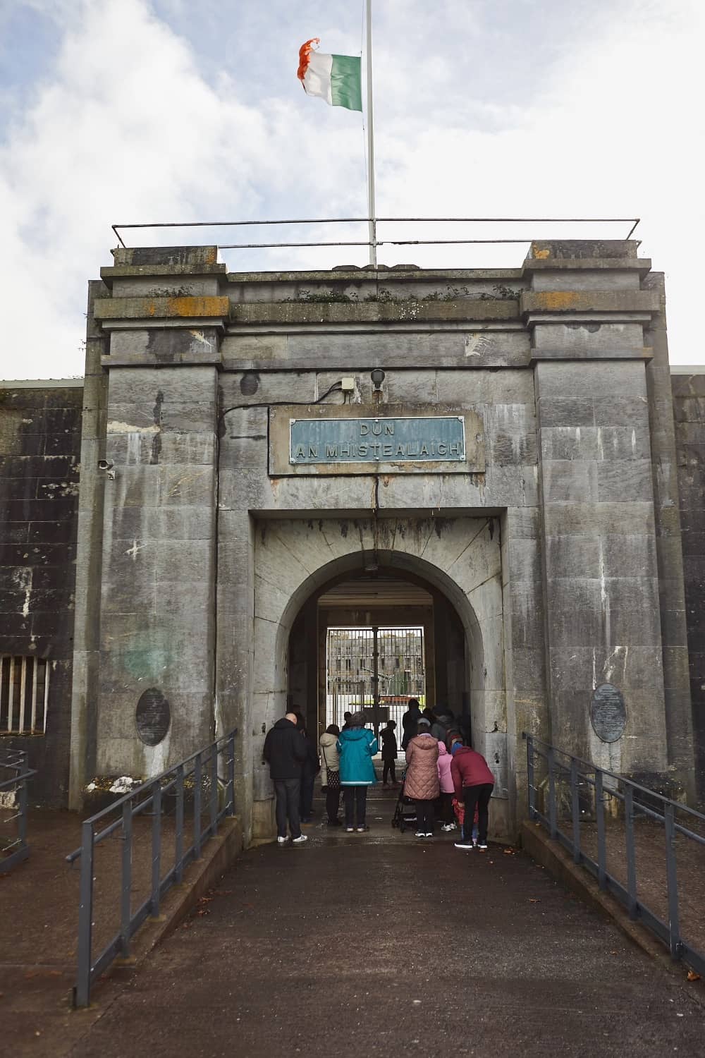 Stone archway entrance to Fort Mitchel on Spike Island with visitors entering.