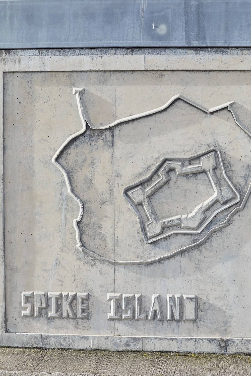Concrete wall map of Spike Island showing fort layout and island outline.
