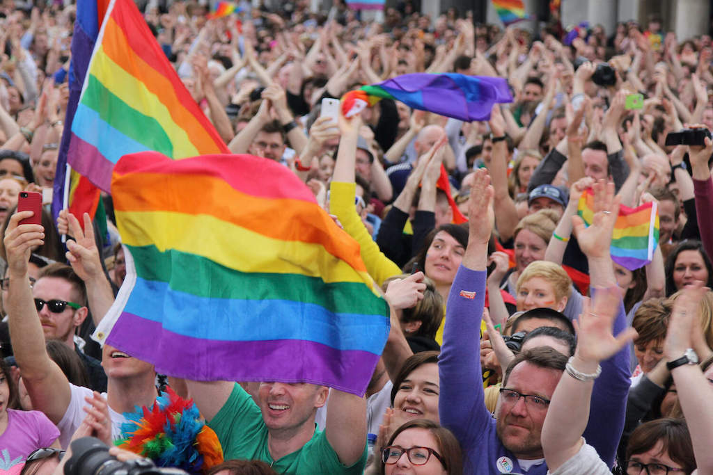 Crowd celebrating with rainbow flags at Ireland’s marriage equality referendum.