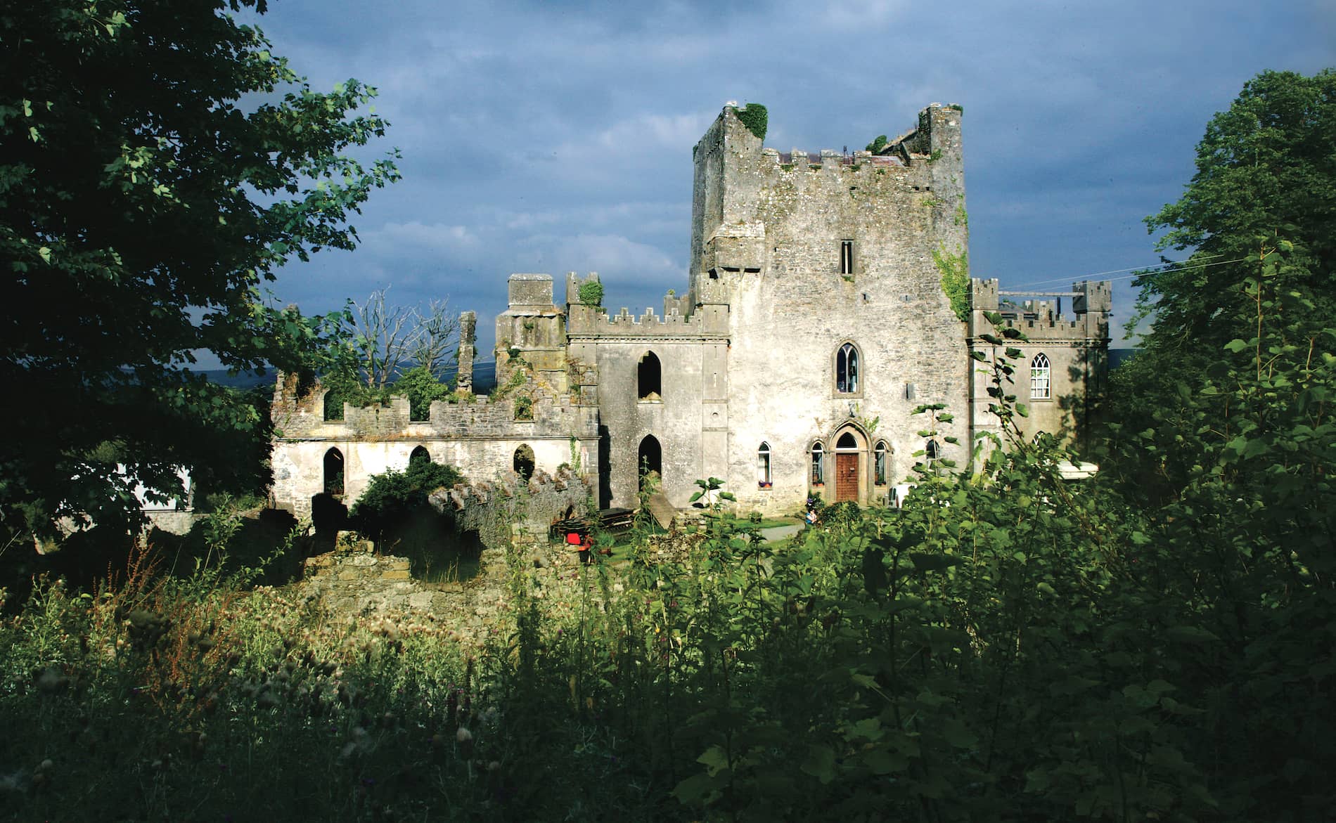 Exterior of Leap Castle, Ireland’s most haunted castle, with ivy-covered ruins and a dramatic stone façade.