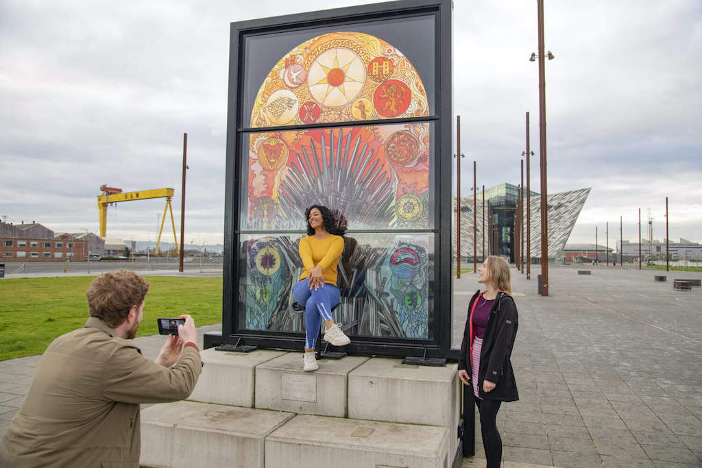 Friends posing by the Game of Thrones stained glass window near Titanic Belfast.
