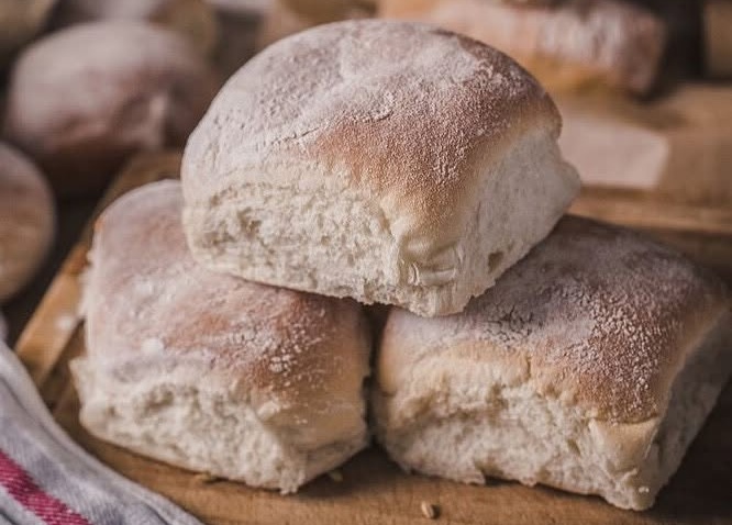 Traditional Waterford blaa bread rolls, freshly baked at Walsh's Bakehouse and dusted with flour.