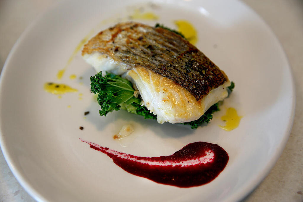 Pan-fried fish served on kale with beetroot purée at Dingle Cookery School, County Kerry.