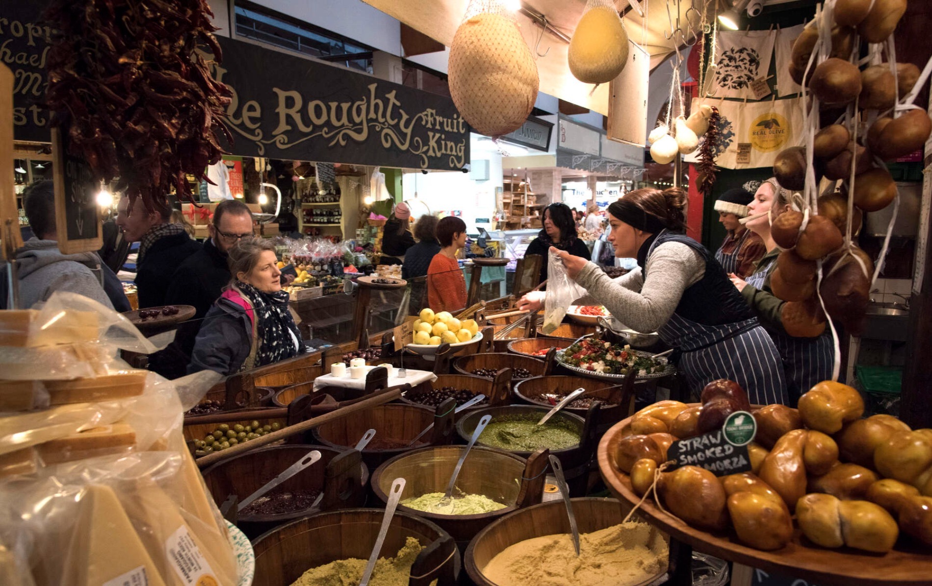Stallholders serving cheese and olives at the busy English Market in Cork city.