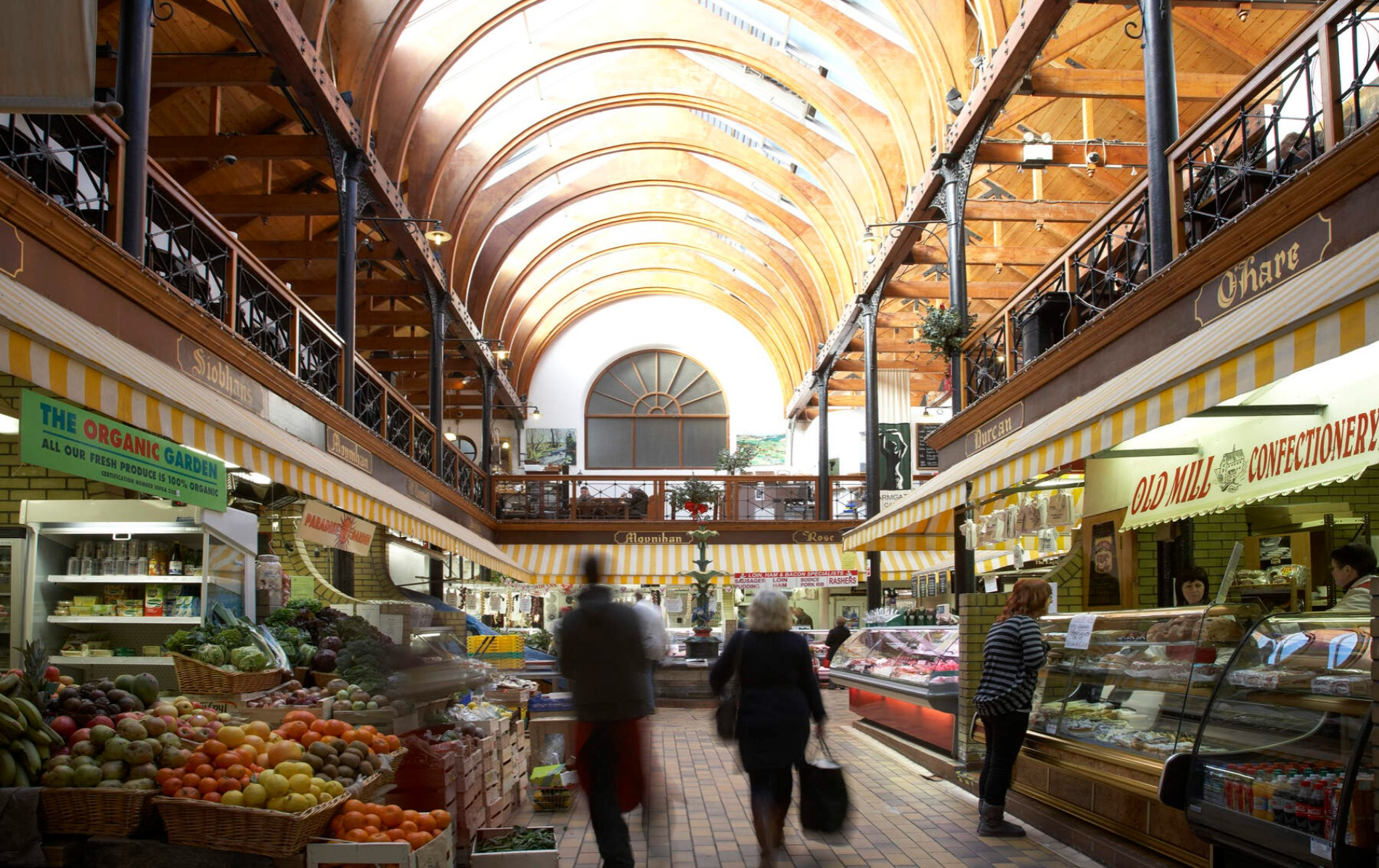 The English Market in Cork city with fresh produce and bakery stalls indoors.