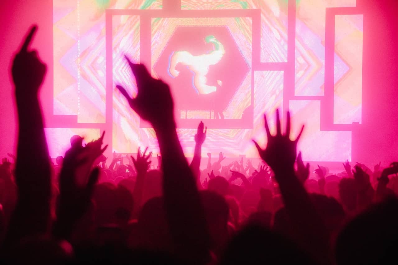 Crowd enjoying a live electronic music performance with colourful stage visuals at the AVA Festival in Belfast.