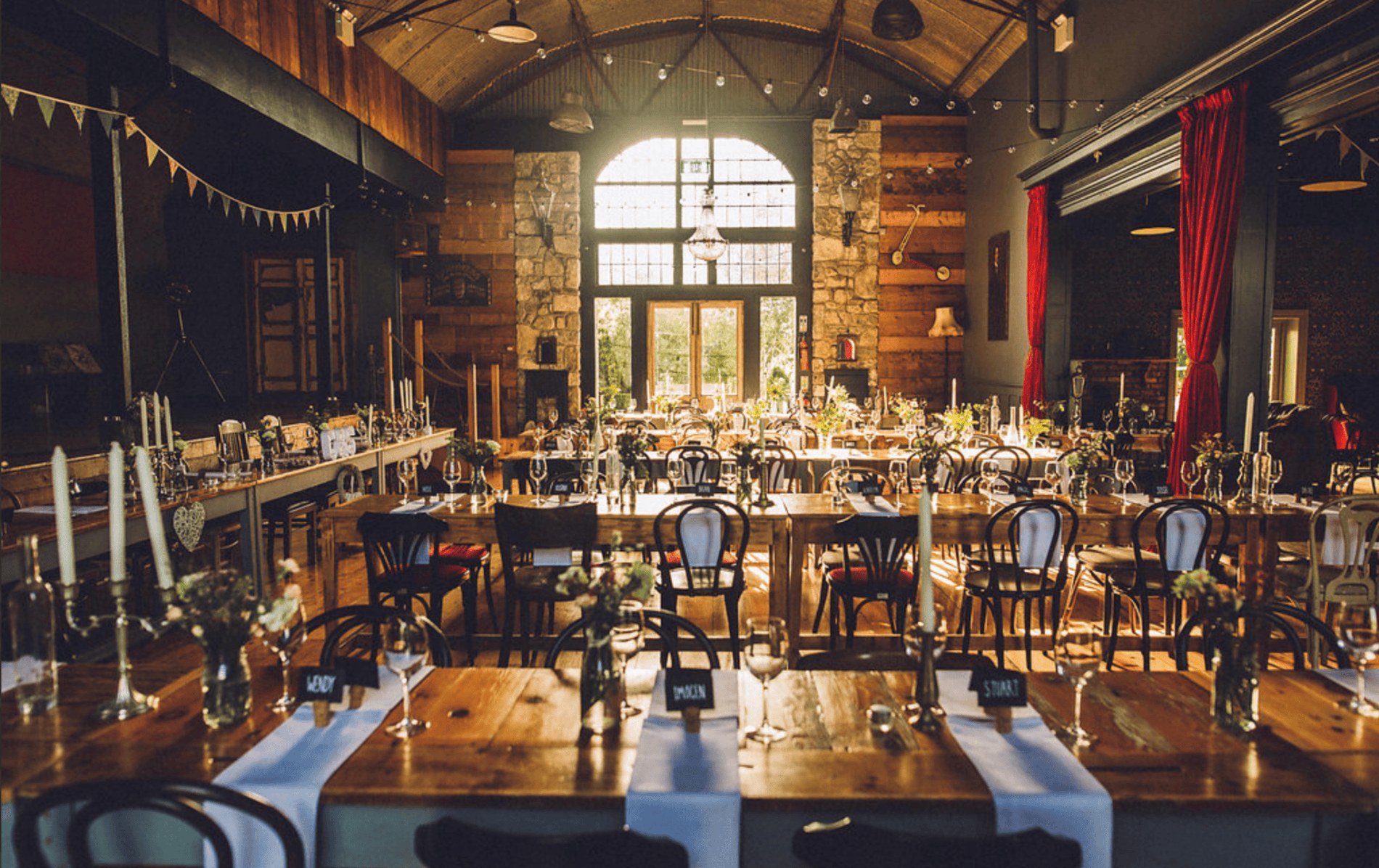 Rustic Tin Chapel at Mount Druid, Westmeath, set for a wedding with long tables, vintage chairs and warm decor.