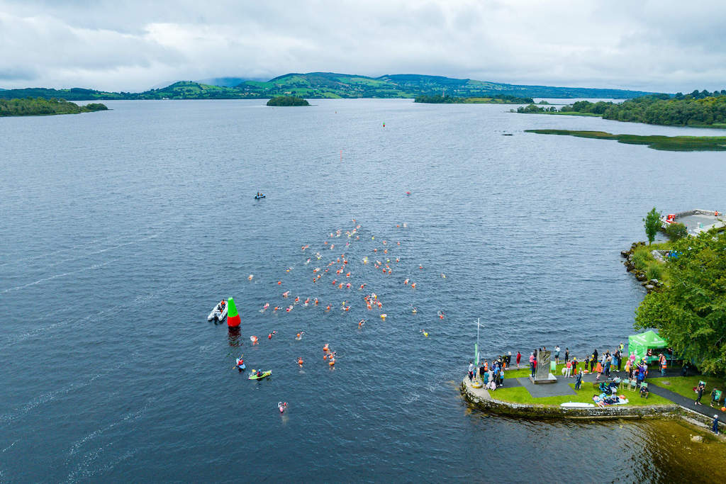 Aerial view of swimmers in brightly coloured caps taking part in the Gaelforce Great Lake Swim on Lough Derg, County Clare.
