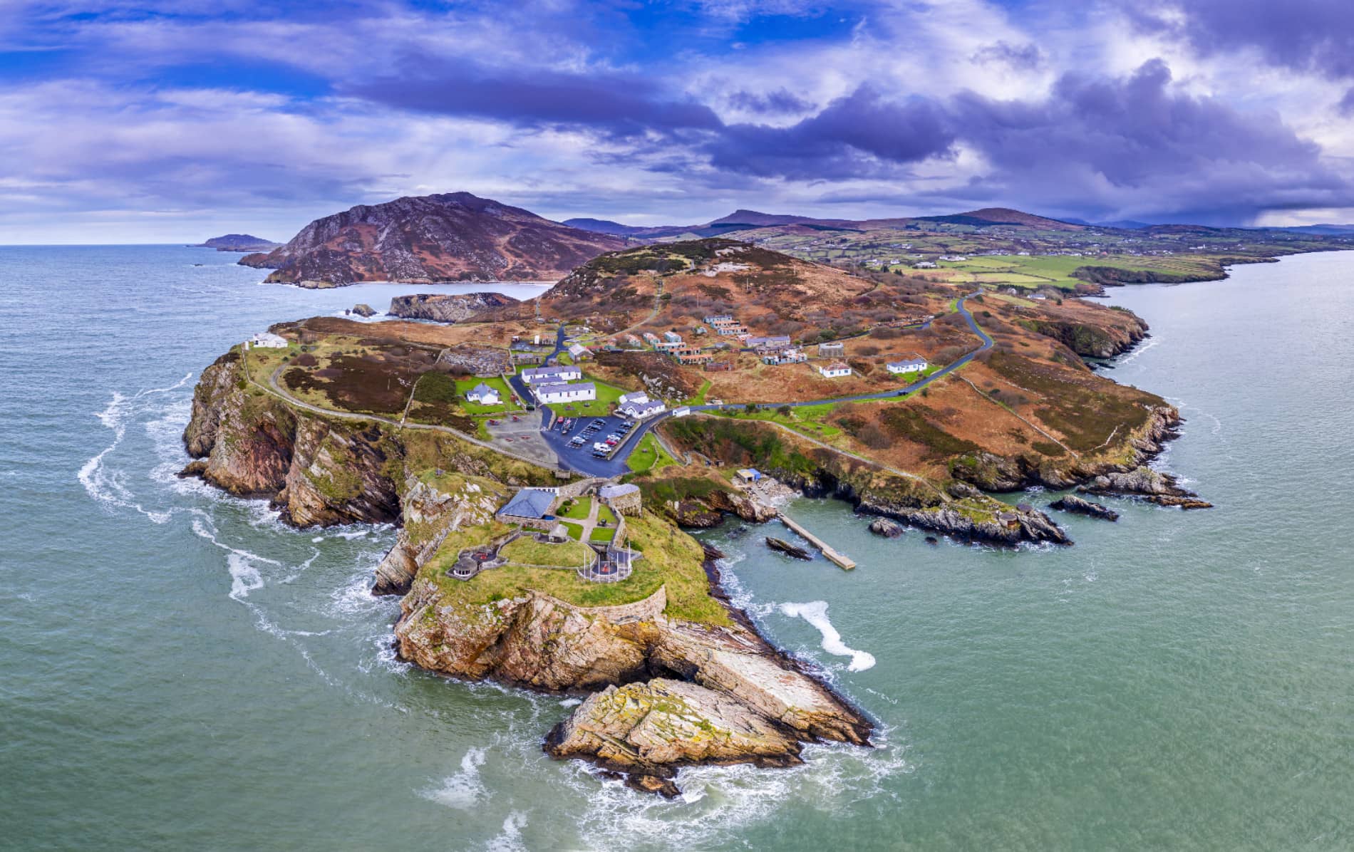 Aerial view of Malin Head, Donegal, showing rugged coastline, scattered houses and winding roads.